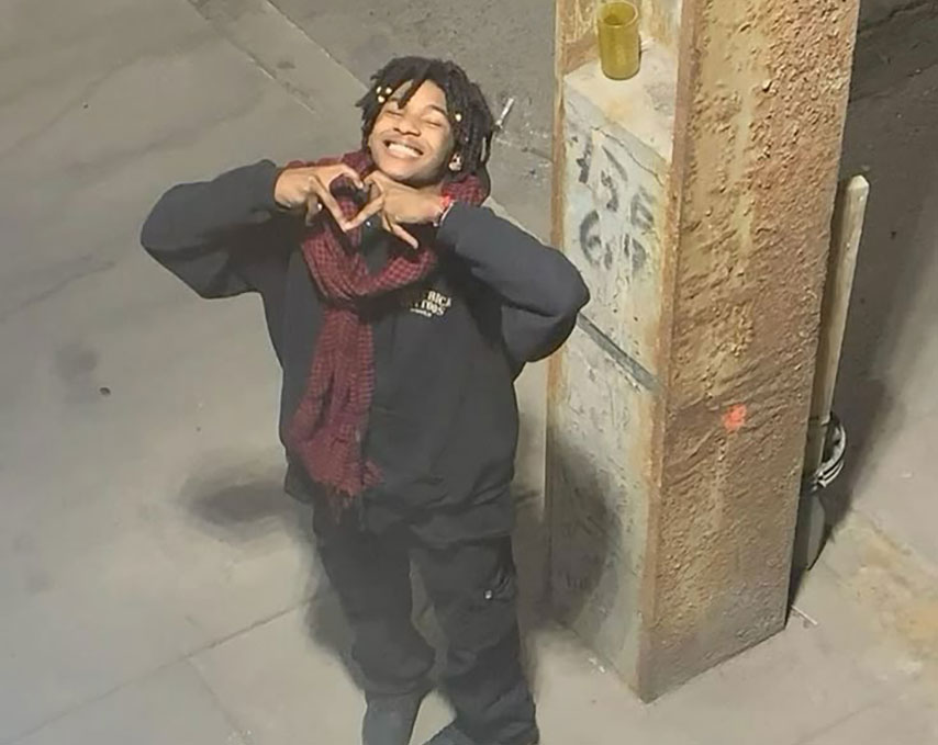 boy doing heart hand symbol